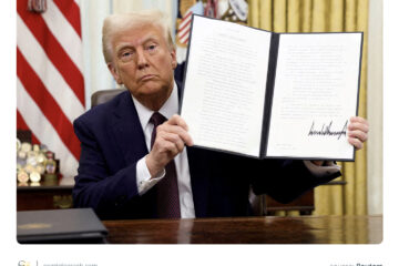US President Donald Trump holding a signed executive order on cryptocurrencies, in the  White House, January 23, 2025